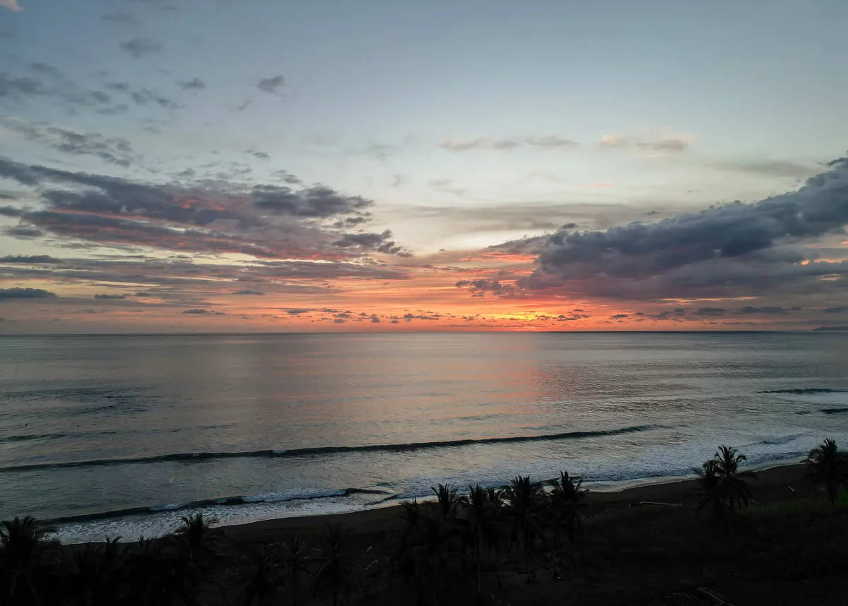 Pacific sunset seen above Playa Hermosa and the palms of Hermosa Palms